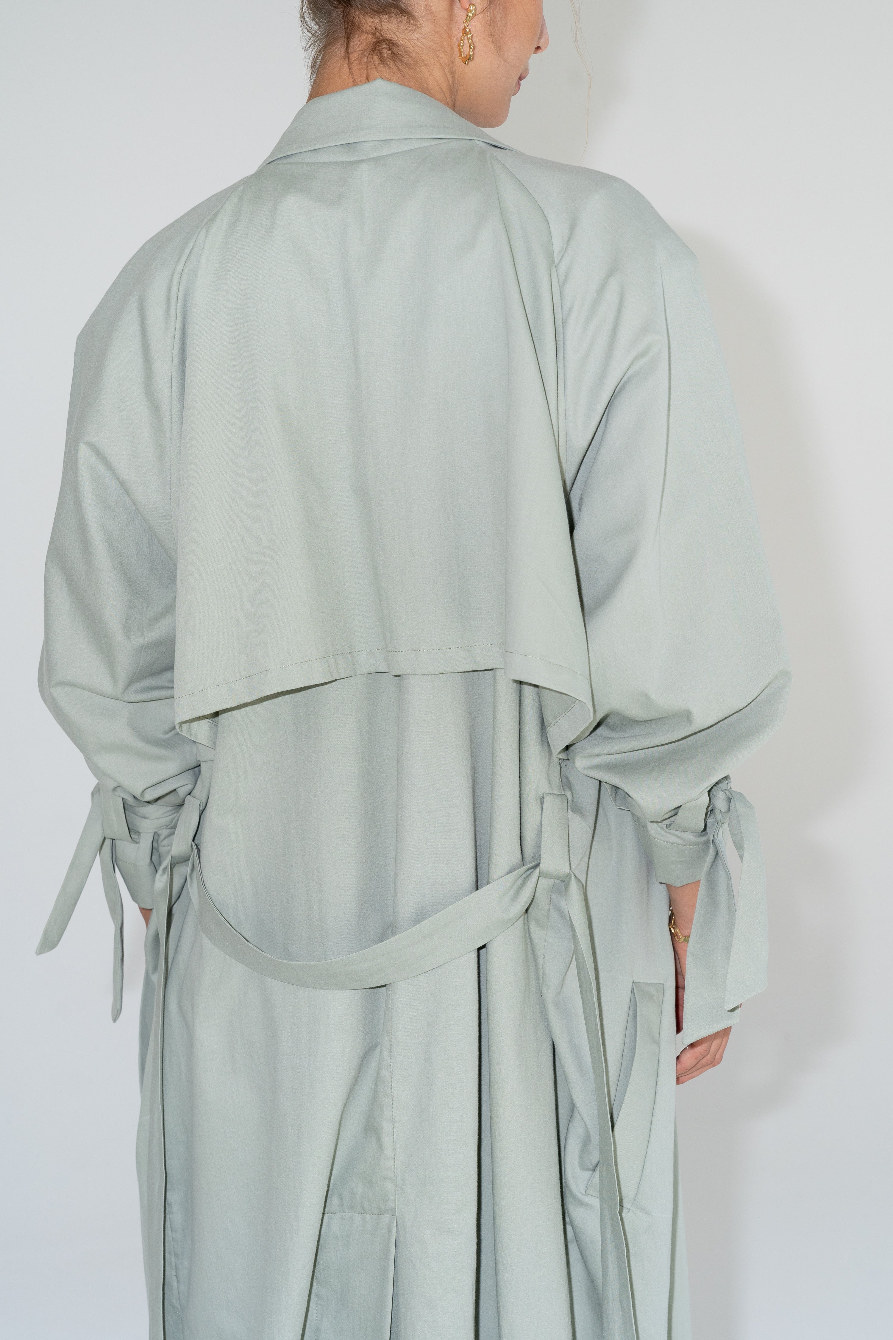 Back detail of ADVA Studios Olive Green Trenchcoat made from organic cotton.