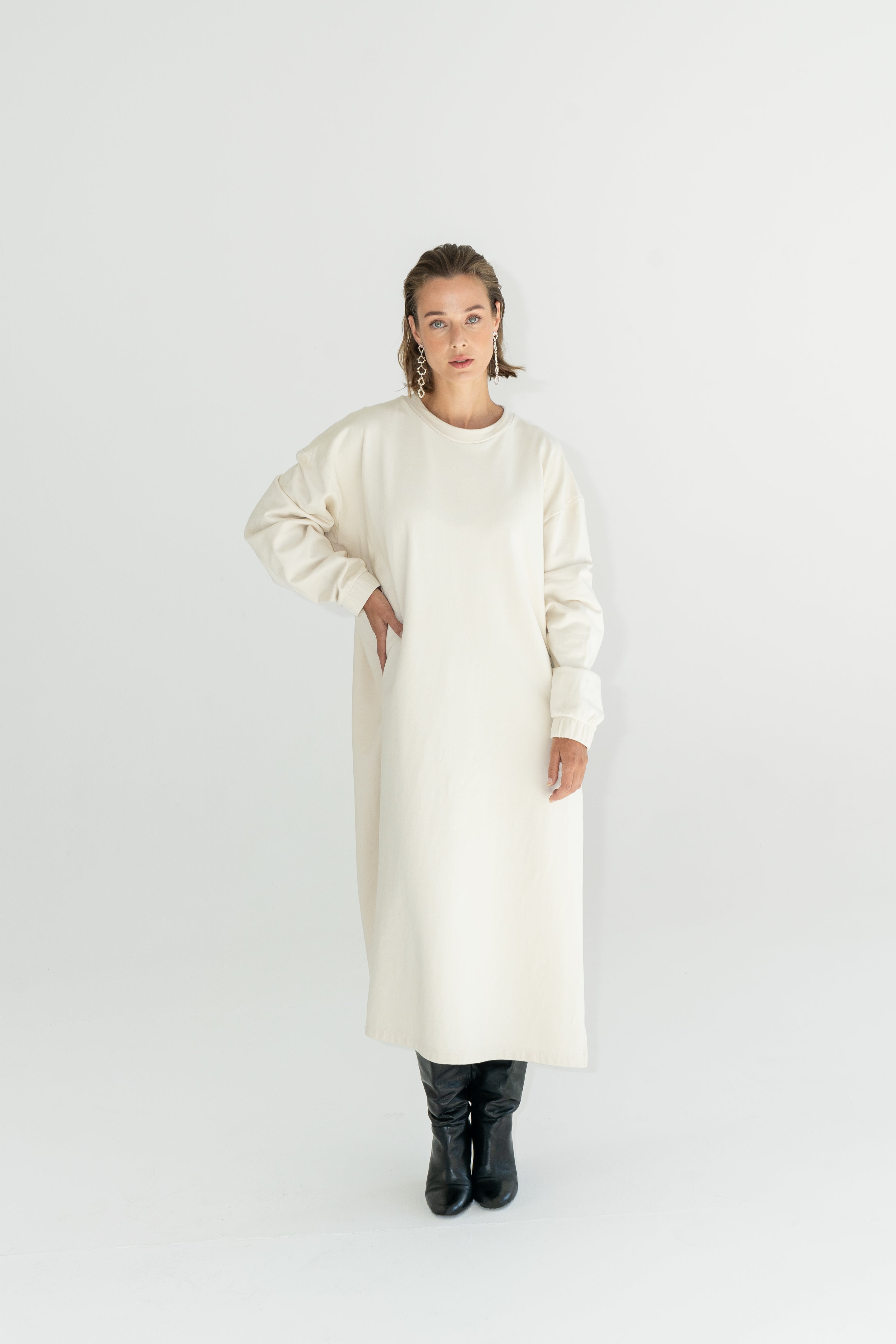 Model in ADVA oversized sweatshirt dress in offwhite color.