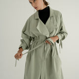 ADVA Studios Olive Green Trenchcoat from organic cotton with black turtleneck.