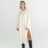 Model in ADVA Studios oversized sweatshirt dress in offwhite color.