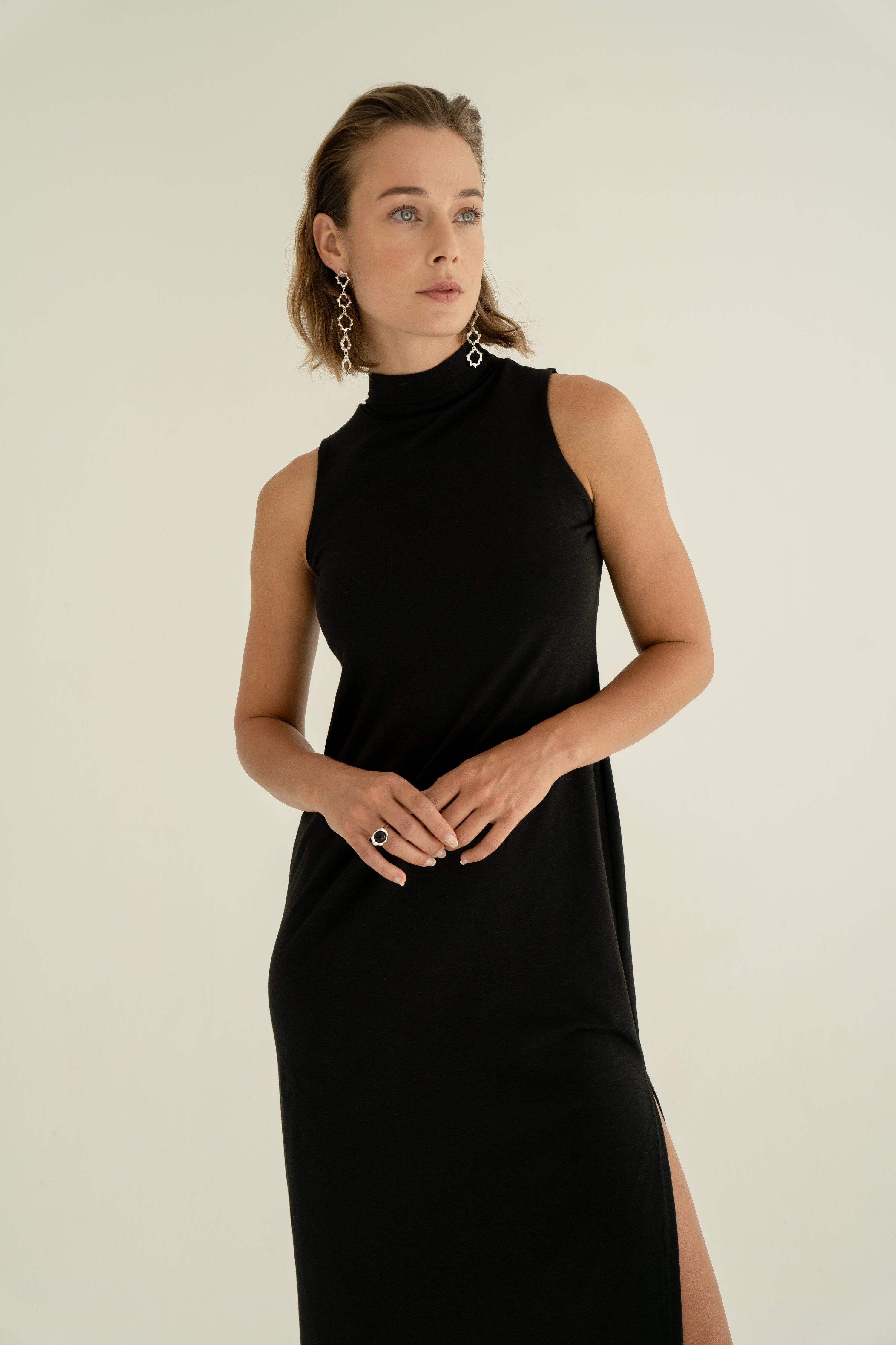 Model in ADVA black turtleneck dress.